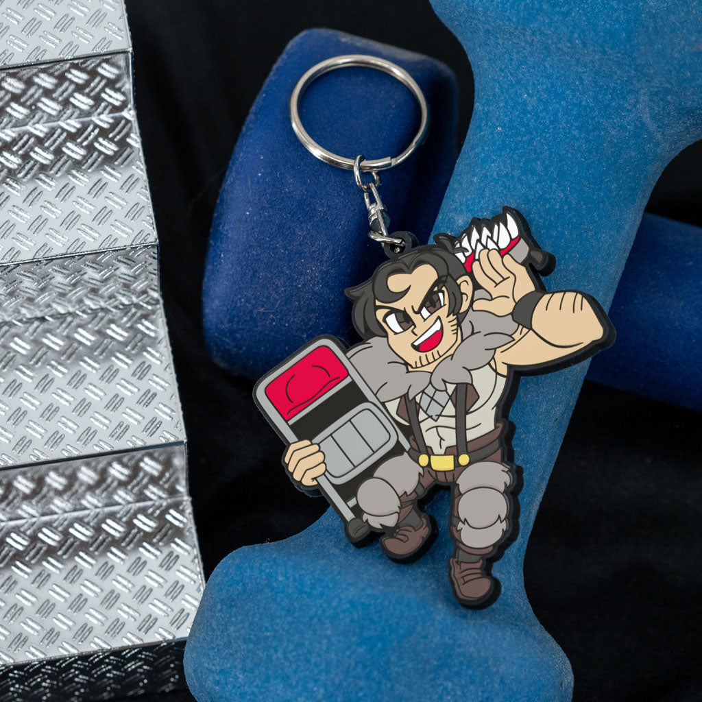 Skullgirls Beowulf keychain on a set of weights and some metal stairs.