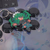 Skullgirls Fukua keychain on top of an arcade stick with her artwork from Skullgirls in the background.