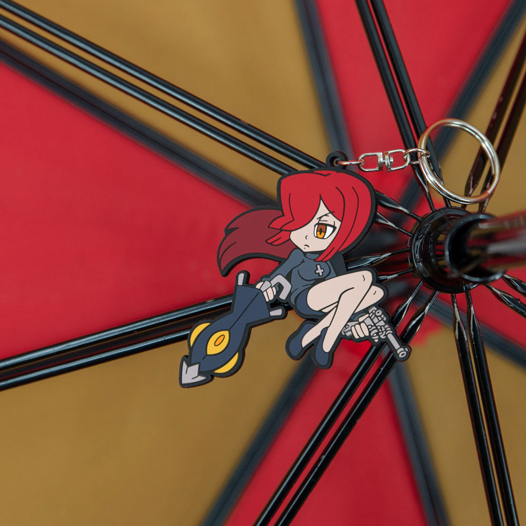 Skullgirls Parasoul keychain shown inside of an umbrella with matching red and gold hues.