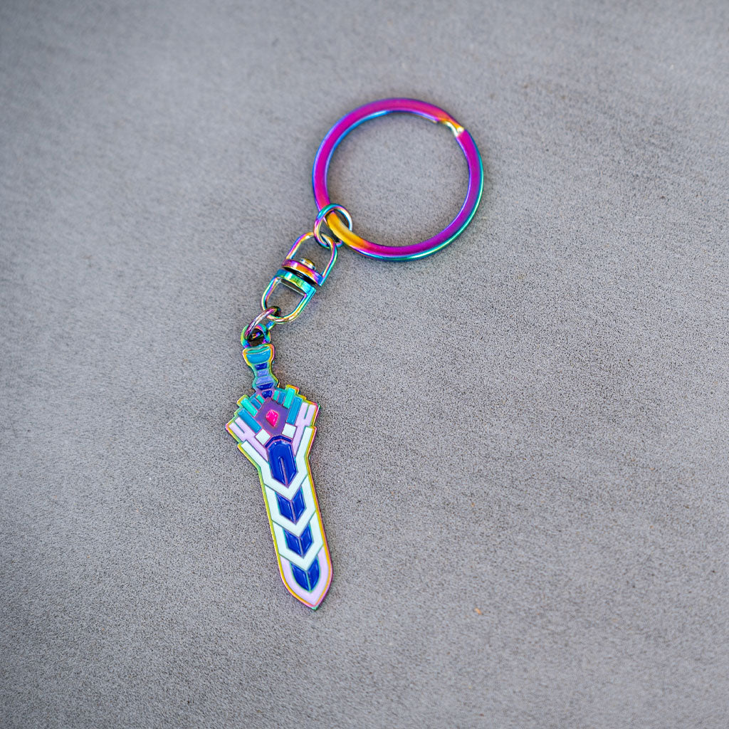 Photograph of the Terraria Zenith Keychain on a flat grey background showing off it&#39;s rainbow finish.